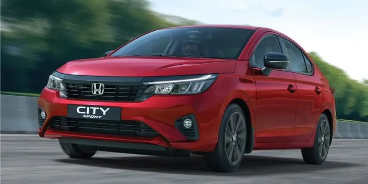 2025 Honda City Sport front view in Radiant Red Metallic with black grille and sporty bumper design