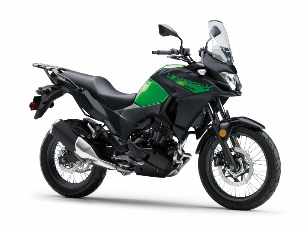 Front three-quarter view of the MY26 Kawasaki Versys-X 300 in green and black, showcasing its adventure styling and tall windscreen
