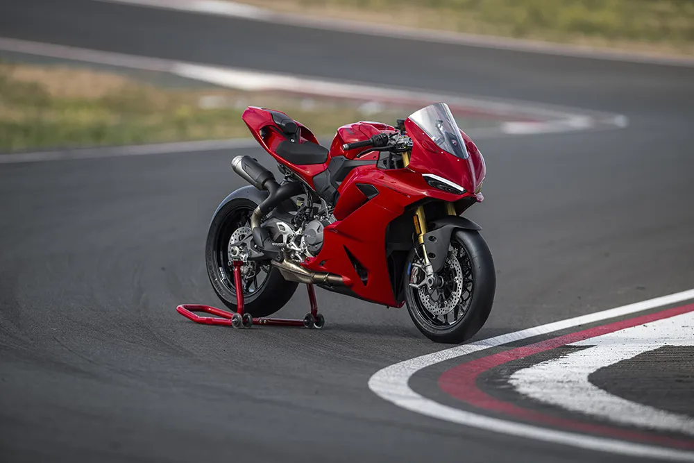 All-new 2025 Ducati Panigale V2 S in Ducati Red parked on a racetrack corner, showcasing its V4-inspired design and Öhlins suspension. All New Ducati Panigale V2 and V2S  Model 2026 Model  