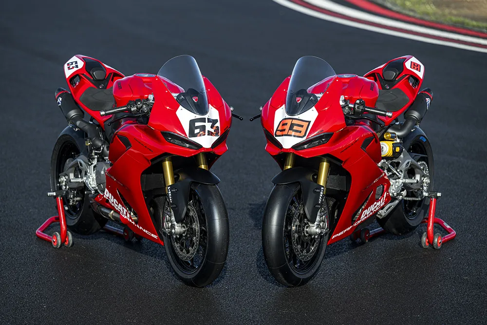 Two 2025 Ducati Panigale V2 S superbikes in Ducati Red with racing numbers 63 and 93, parked side-by-side on a racetrack. Ducati Panigale V2 2026 Model