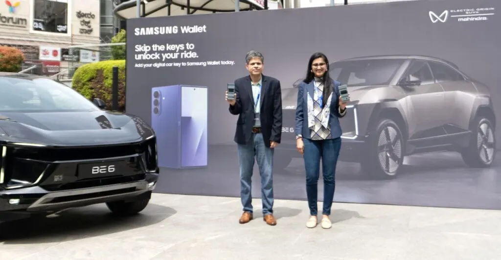 Madhur Chaturvedi from Samsung India and Shruti Agarwal from Mahindra Electric showcasing Digital Car Key support on Galaxy smartphones via Samsung Wallet, standing beside a black Mahindra BE 6 electric SUV.