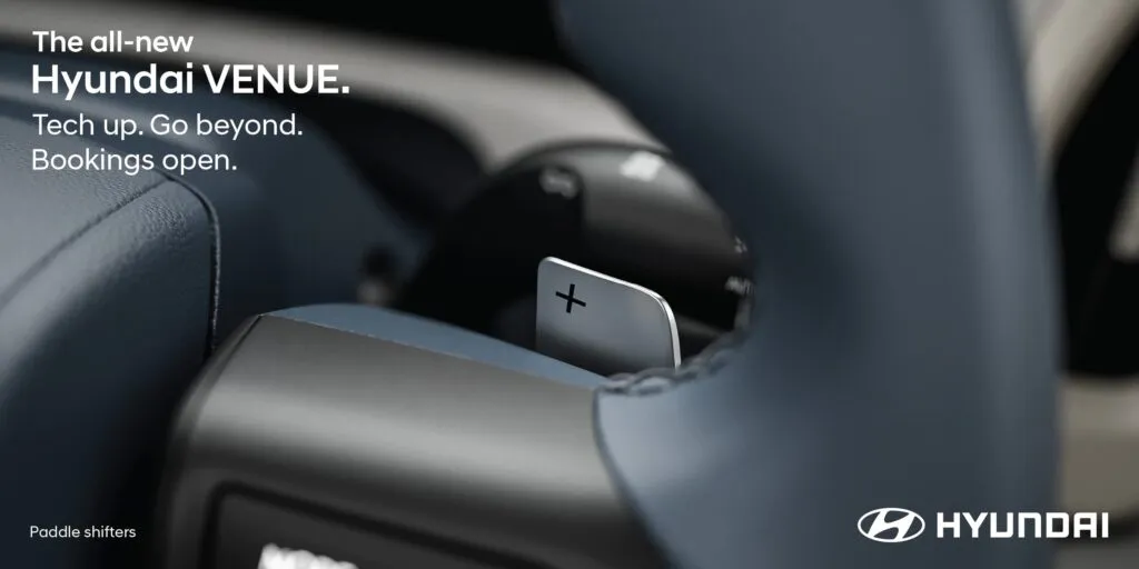 Close-up of the steering wheel-mounted paddle shifters on the all-new 2025 Hyundai Venue, highlighting its sporty automatic transmission features.