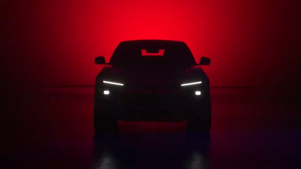 Close-up of the Mahindra BE Rall-E front fascia featuring distinct circular LED projector headlamps and a rugged bash plate.