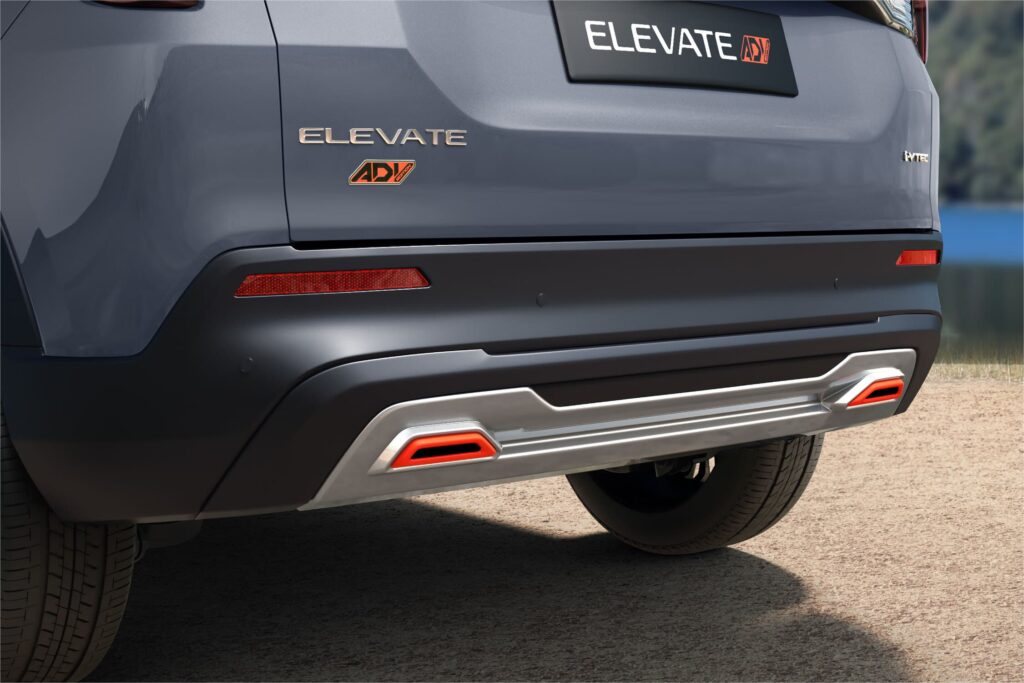 Close-up of the Honda Elevate ADV rear bumper, showing the silver lower garnish and active orange accents around the reflectors, along with the "ELEVATE ADV" badge.